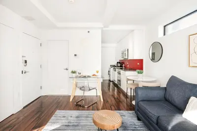 a living room with a couch and a table at 809-5A Gorgeous New 1BR Heart of Midtown in New York