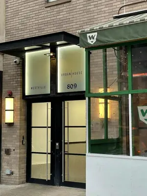 a store front of a building with a green awning at 809-5A Gorgeous New 1BR Heart of Midtown in New York