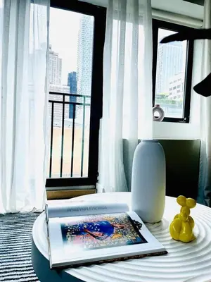a room with a table with a book and a lamp at 809-6A NEW 2BR Private Roof & City View in New York