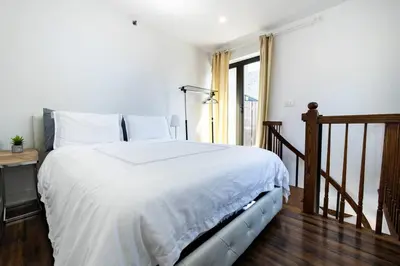 a bedroom with a large bed with white sheets at 809-6B 2BR Duplex Breathtaking Views Beauty in New York