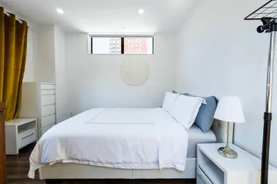 a white bedroom with a white bed and a window at 809-6B 2BR Duplex Breathtaking Views Beauty in New York