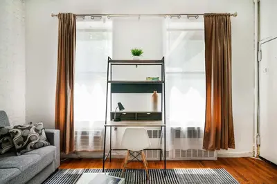 a living room with a couch and a table at 26-2B Gramercy Large 1BR WD in unit courtyard in New York