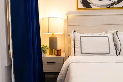 a bedroom with a bed with a blue curtain at 69-2D Stylish Lower East Side 1BR Apt BRAND NEW in New York