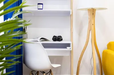 a desk with a white chair next to a plant at 69-2D Stylish Lower East Side 1BR Apt BRAND NEW in New York
