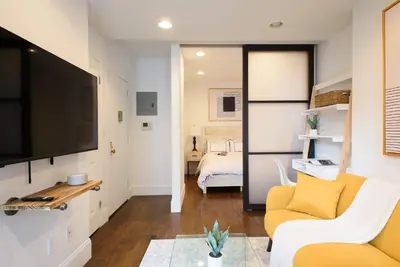 a living room with a couch and a tv at 69-5A Modern Lower East Side 1BR Apt BRAND NEW in New York
