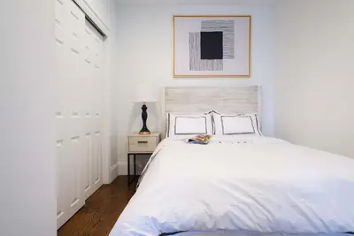 a white bedroom with a white bed and a lamp at 69-5A Modern Lower East Side 1BR Apt BRAND NEW in New York