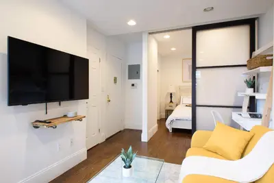 a living room with a flat screen tv on a wall at 69-5A Modern Lower East Side 1BR Apt BRAND NEW in New York