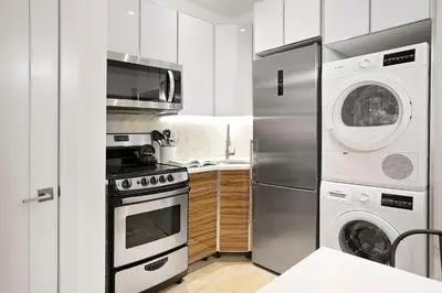 a kitchen with a refrigerator and a washer and dryer at 24-6 Gramercy area Newly reno Studio W D in unit in New York