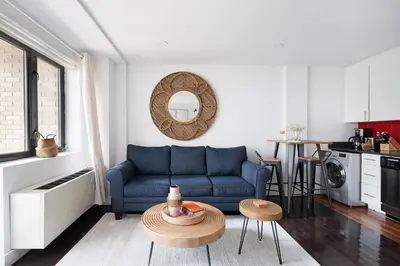 a living room with a blue couch and a table at 809-2B New bldg Jr columbus circle Balcony WD in New York