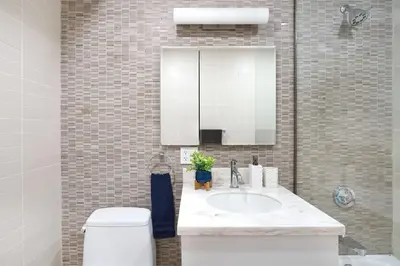 a bathroom with a sink and a toilet and a mirror at 809-2B New bldg Jr columbus circle Balcony WD in New York