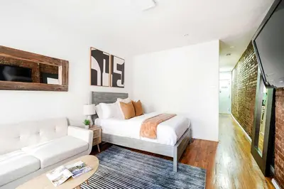 a white bedroom with a bed and a couch at 26-3A STUDIO Gramercy W D Outdoor Courtyard in New York