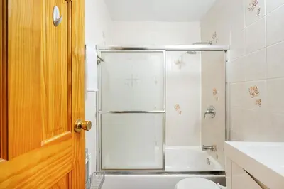 a bathroom with a shower and a white tub at 26-3A STUDIO Gramercy W D Outdoor Courtyard in New York