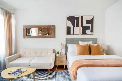 a bedroom with a king sized bed and a couch at 26-3A STUDIO Gramercy W D Outdoor Courtyard in New York