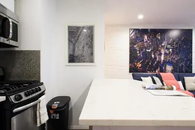 a kitchen with a stove and a white counter top at 26-4B Newly Furnished 1BR W D Courtyard in New York