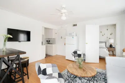 a white living room with a table and chairs at 11-4F Prime west village designer 1BR in New York