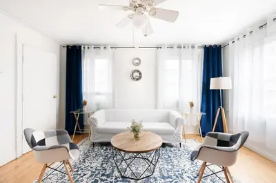 a living room with a white couch and chairs at 11-4F Prime west village designer 1BR in New York