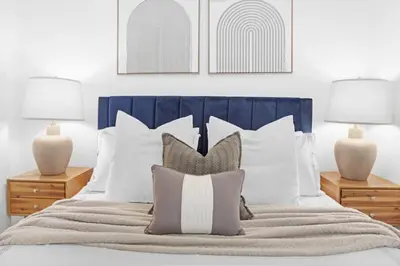 a bedroom with a bed with pillows and two lamps at 139-2E west village 1BR best value in New York