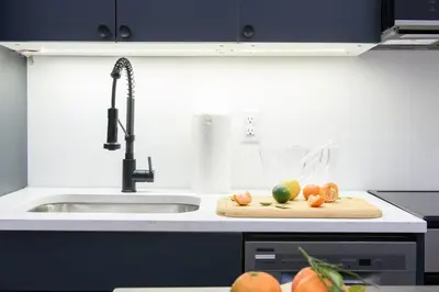 a kitchen with a sink and a cutting board with fruit at 3-1 New Prime East Village Private Terrace in New York