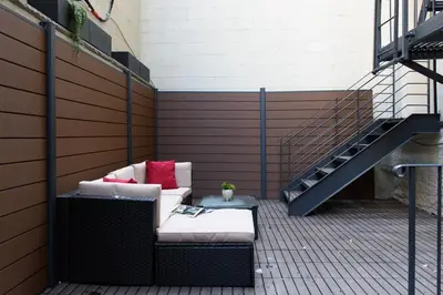 a patio with a couch and a stair case at 3-1 New Prime East Village Private Terrace in New York