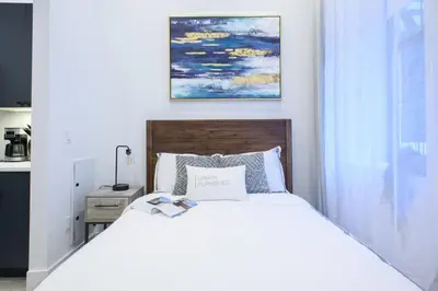 a bedroom with a white bed and a painting on the wall at 3-1 New Prime East Village Private Terrace in New York