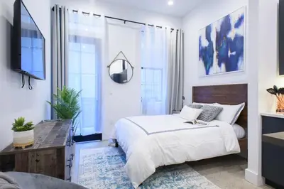 a bedroom with a large bed and a television at 3-2 NEW Prime E Village Private outdoor! in New York