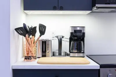 a kitchen counter with a coffee maker and utensils at 3-2 NEW Prime E Village Private outdoor! in New York