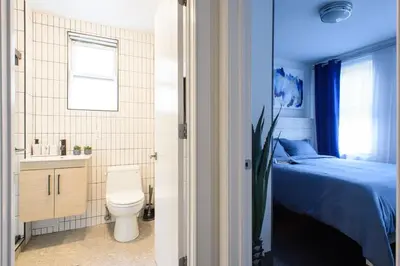 a bedroom with a bed and a toilet and a sink at 39-1 Renovated 3BR Prime Midtown West in New York