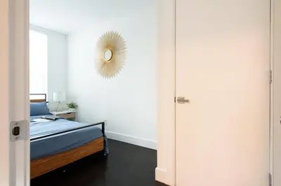 a bedroom with a bed and a mirror on the wall at 39-1 Renovated 3BR Prime Midtown West in New York