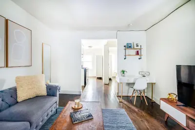 a living room with a couch and a table at 39-3 Newly renovated 3 BR Prime midtown sleeps 6 in New York