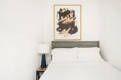 a bedroom with a bed and a picture on the wall at 428-2E Newly furnished 2BR Prime Midtown sleeps 5 in New York