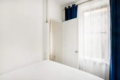 a white bedroom with a bed and a window at 428-2E Newly furnished 2BR Prime Midtown sleeps 5 in New York