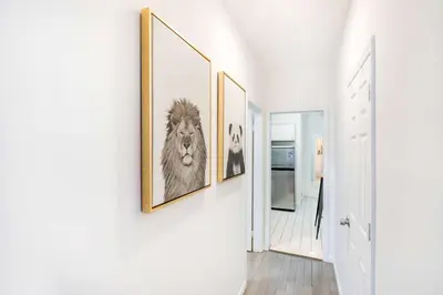 a hallway with three framed pictures on a wall at 428-2E Newly furnished 2BR Prime Midtown sleeps 5 in New York