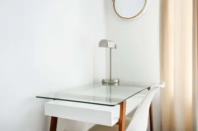 a glass table with a mirror and a white chair at 428-2E Newly furnished 2BR Prime Midtown sleeps 5 in New York