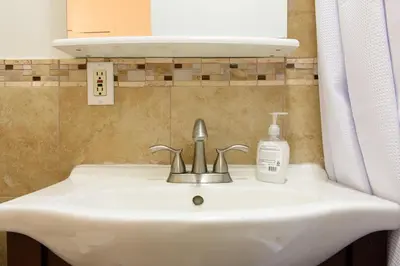 a bathroom sink with a bottle of soap on it at 428-2E Newly furnished 2BR Prime Midtown sleeps 5 in New York