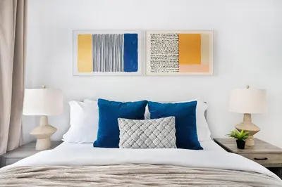 a bed with blue and white pillows and two lamps at 350-1A Gramercy New 1BR Sleeps4 Newly Furnished in New York