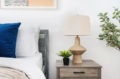 a bedroom with a bed and a table with a lamp at 350-1A Gramercy New 1BR Sleeps4 Newly Furnished in New York