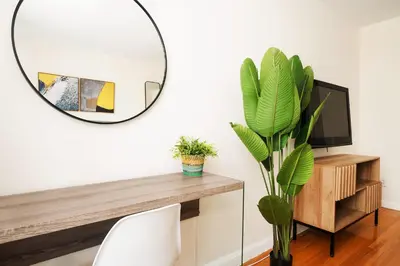 a mirror in a living room with a table and a plant at 338-3B union square Newly Reno Sleeps 3 in New York