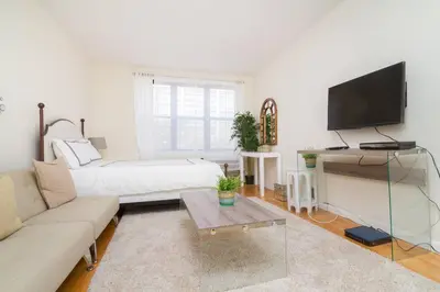 a living room with a couch and a flat screen tv at 338-3B union square Newly Reno Sleeps 3 in New York