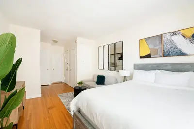 a white bedroom with a bed and a couch at 338-3B union square Newly Reno Sleeps 3 in New York