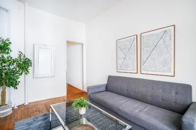 a living room with a couch and a glass table at 211-3 Prime Union Square Large 1BR Great value in New York