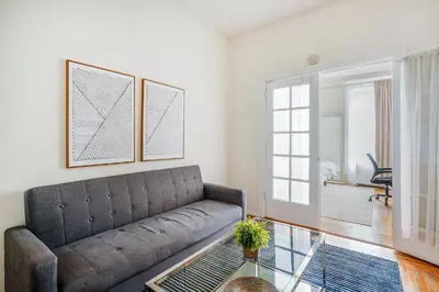 a living room with a couch and a glass table at 211-3 Prime Union Square Large 1BR Great value in New York