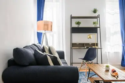 a living room with a blue couch and a table at 428-3R Spacious Prime Midtown 2BR Newly furnished in New York