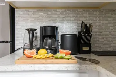 a cutting board with fruit on top of a kitchen counter at 428-3R Spacious Prime Midtown 2BR Newly furnished in New York