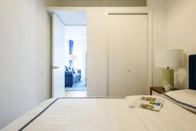 a bedroom with a bed and a door to a living room at 428-3R Spacious Prime Midtown 2BR Newly furnished in New York