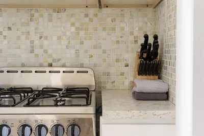 a kitchen with a stove and a counter with knives at 428-4R prime midtown large 2 BR Newly Furnished in New York