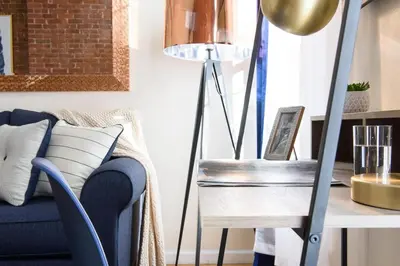 a living room with a blue couch and a table with a lamp at 428-4R prime midtown large 2 BR Newly Furnished in New York
