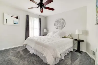a white bedroom with a bed and a ceiling fan at Calm Columbia Haven Outdoor Pool, Hot Tub! in Delaware Water Gap