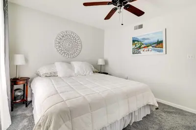 a white bedroom with a bed and a ceiling fan at Calm Columbia Haven Outdoor Pool, Hot Tub! in Delaware Water Gap