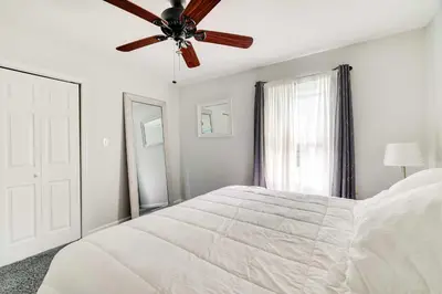 a white bedroom with a ceiling fan and a bed at Calm Columbia Haven Outdoor Pool, Hot Tub! in Delaware Water Gap