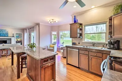 an open kitchen with a large island and a living room at Calm Columbia Haven Outdoor Pool, Hot Tub! in Delaware Water Gap